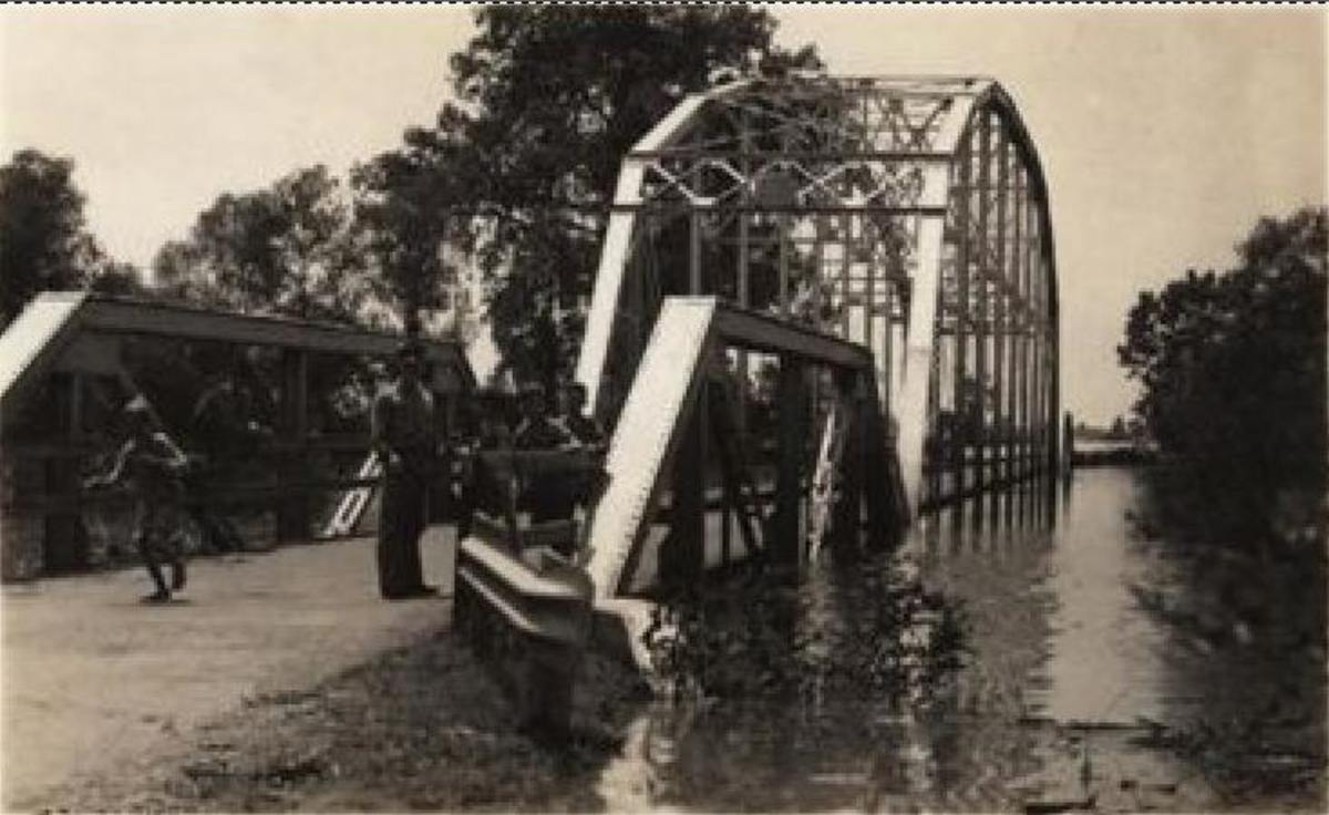 Poteau River Flood of 1943.  The US-271 Poteau River bridge during the May 1943 flood. Note the high water line on the right girder of the thru truss bridge.