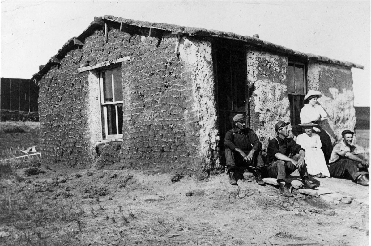 Early day Oklahoma pioneers and their sod homes.